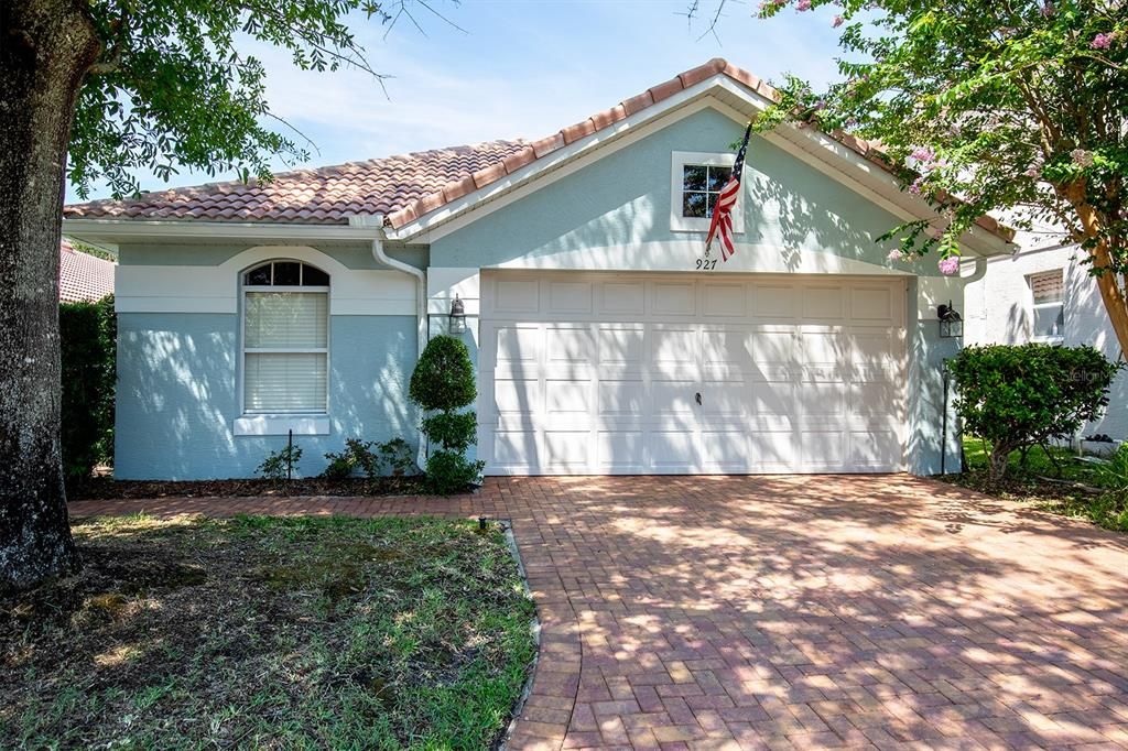 Lush landscaping and brick paver driveway welcomes you. Cozy front entry porch is the perfect transition into this home.