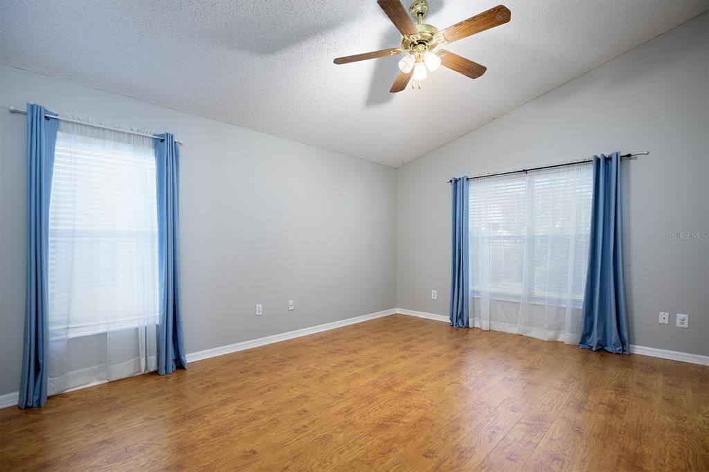 Master bedroom and bathroom suite have bamboo laminate floors, vaulted ceiling and contemporary color palettes.