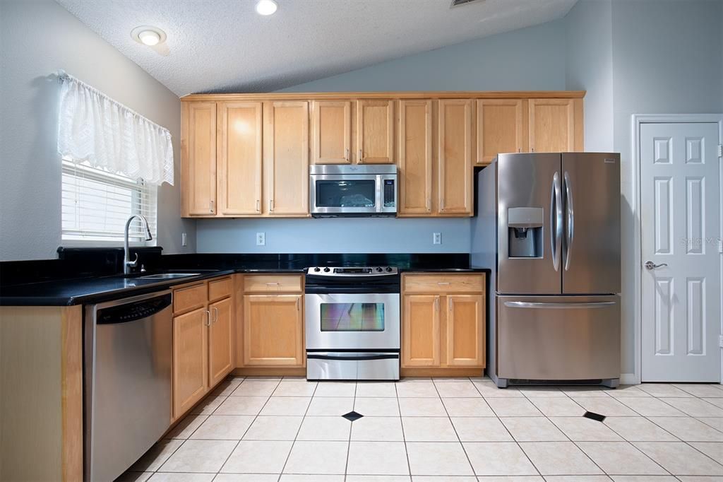 PULL OUT Shelves are an excellent mix of organization and functionality. GRANITE prep space/counters and STAINLESS-STEEL appliances.