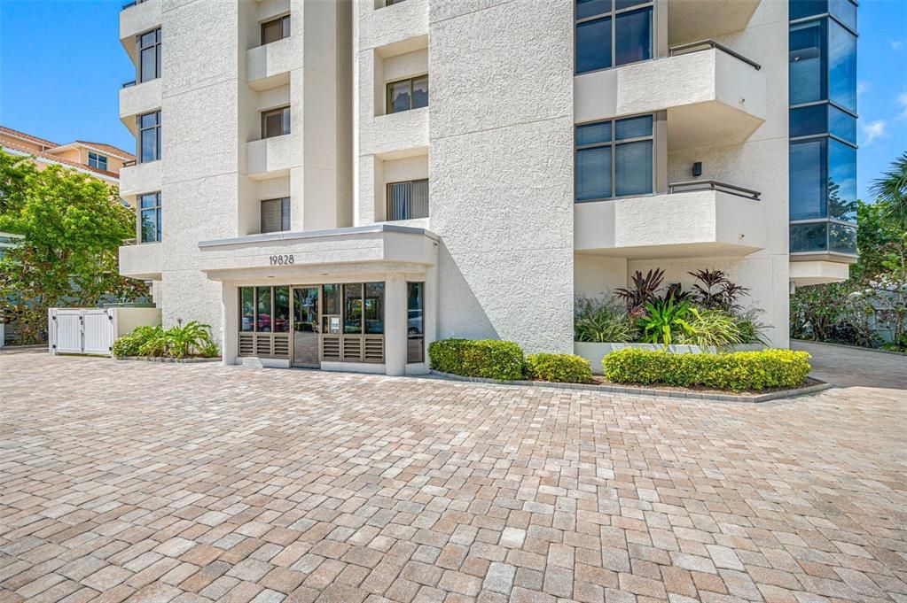 Front exterior, paver drive, secured lobby