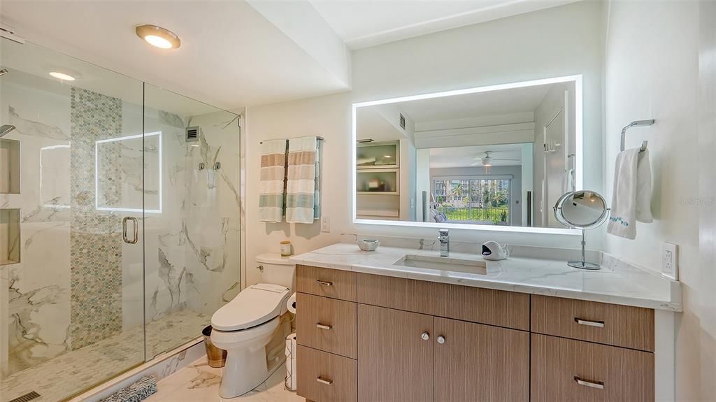 Completely remodeled primary bathroom incorporates high quality modern finishes