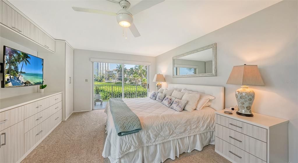 Primary bedroom incorporates new built-in cabinetry and entertainment center