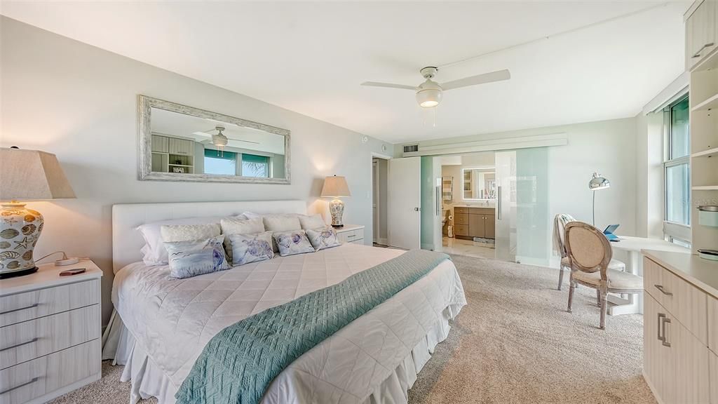 Primary bedroom is the perfect retreat! You can watch a movie and glance at the Gulf all at once...