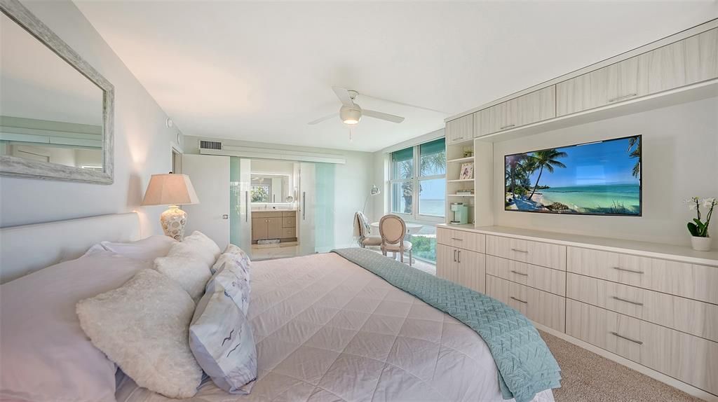 Primary bedroom access to bathroom via glass barn doors