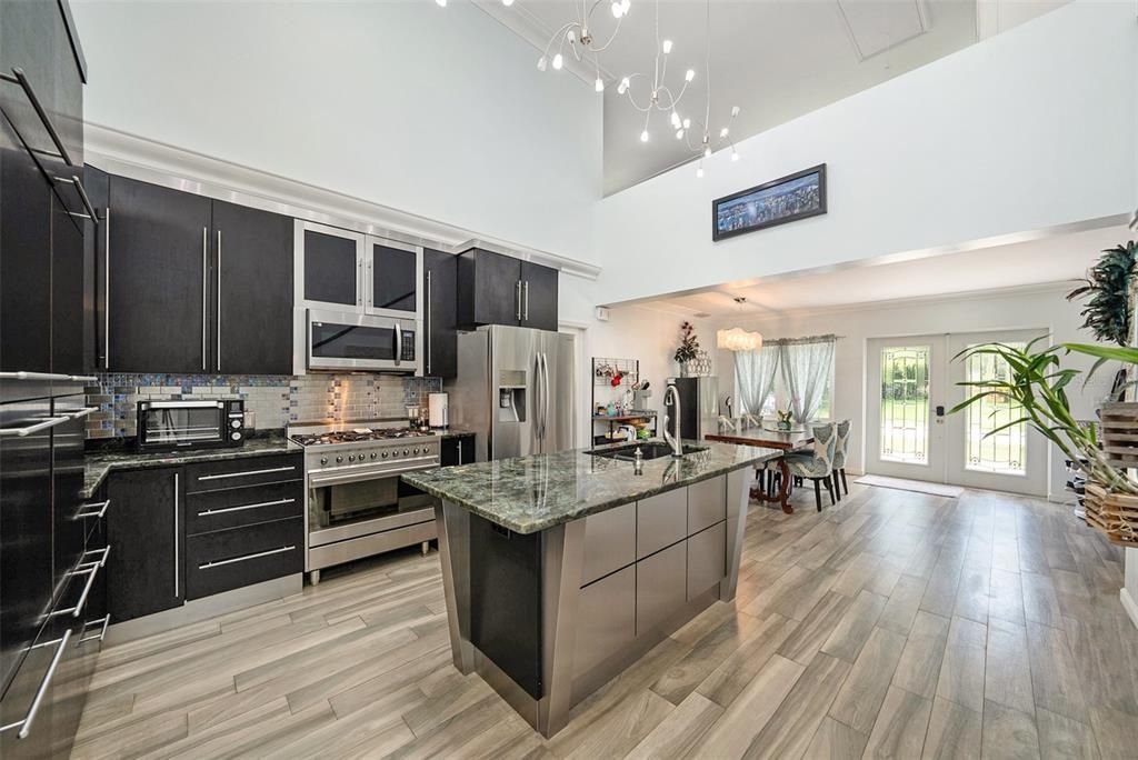 Perfect custom-built kitchen with European cabinets (tower pull outs), Labradorite countertops and a professional Smeg 9 burner gas stove/oven!