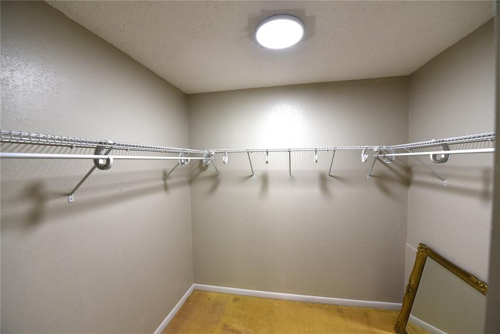 Primary bedroom walk-in closet