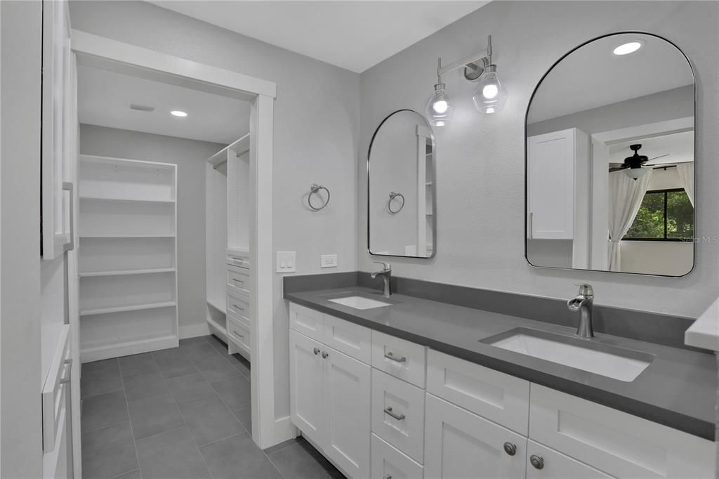 Primary Bathroom with double vanity and custom designed walk-in closet