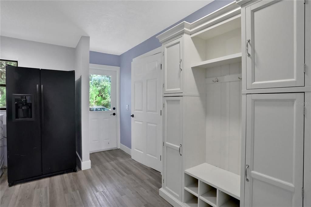 Side Entrance into foyer/mudroom with custom built storage.