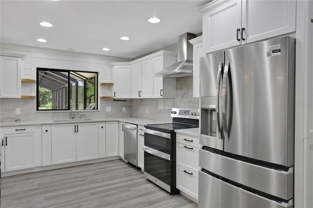 Kitchen with views of the pool and outdoor kitchen