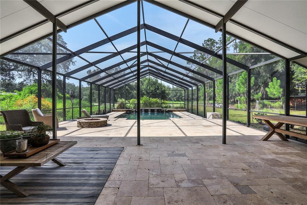 Custom Built Pool (22' X 25') with pool enclosure. Travertine Pavers throughout. Custom Fire Pit.