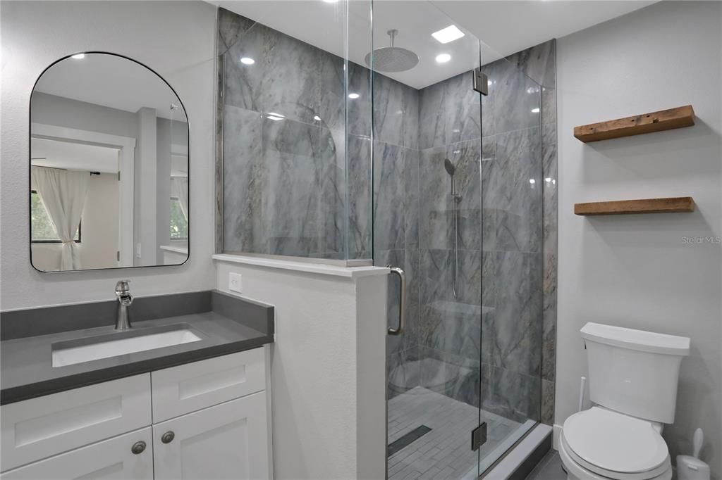 Primary Bathroom with Walk-In Shower with handheld shower head and a rain shower head