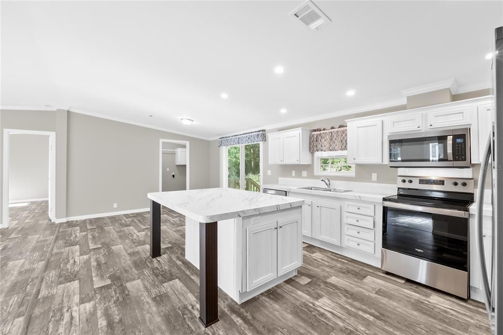 Kitchen w/view of Dinette + Laundry Room