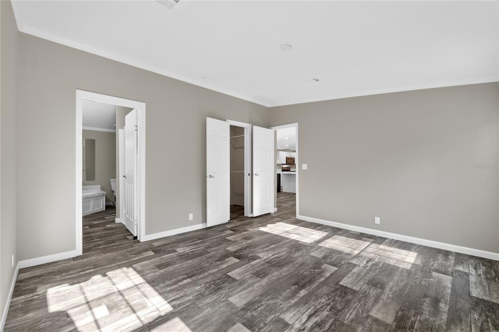 Primary Bedroom w/Entry to En-Suite and Walk-In Closet