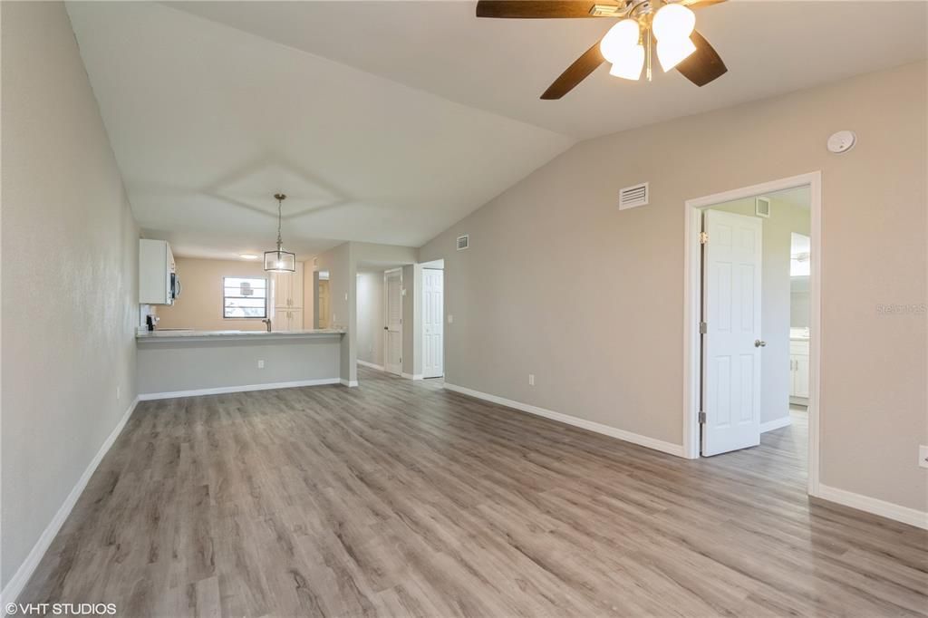 living room/dining combo layout facing kitchen from sliders