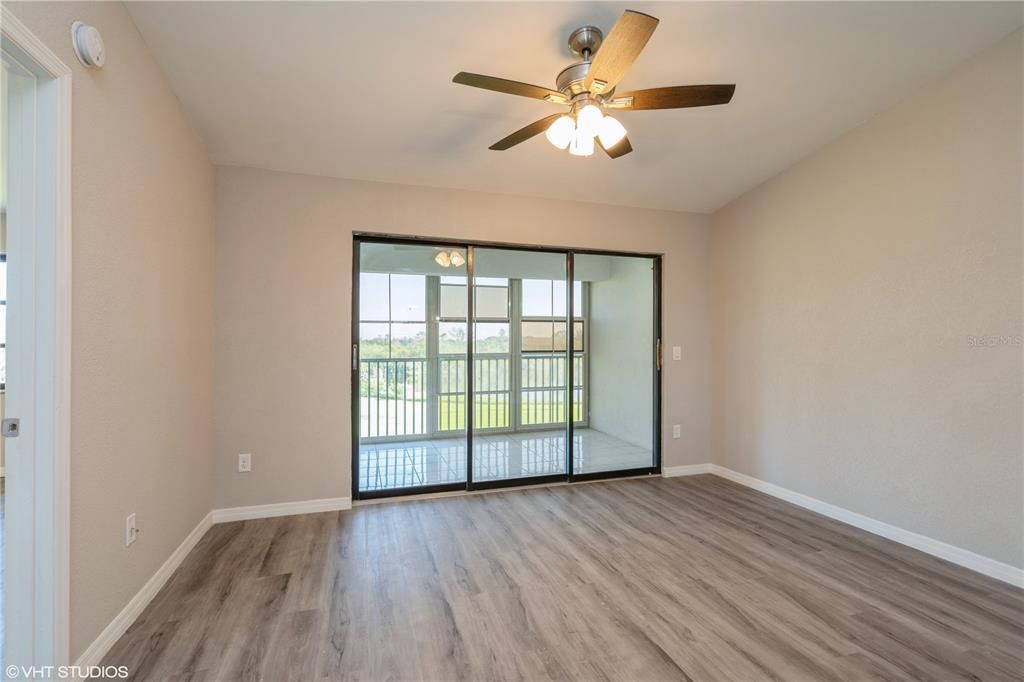 living room end with triple sliders to screened lanai