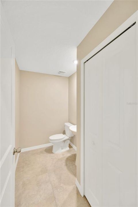 Convenient half bathroom in front hallway.