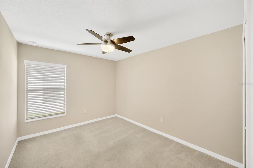 Secondary bedroom #2 is 12' x 10' with ceiling fan, built-in closet and carpet.