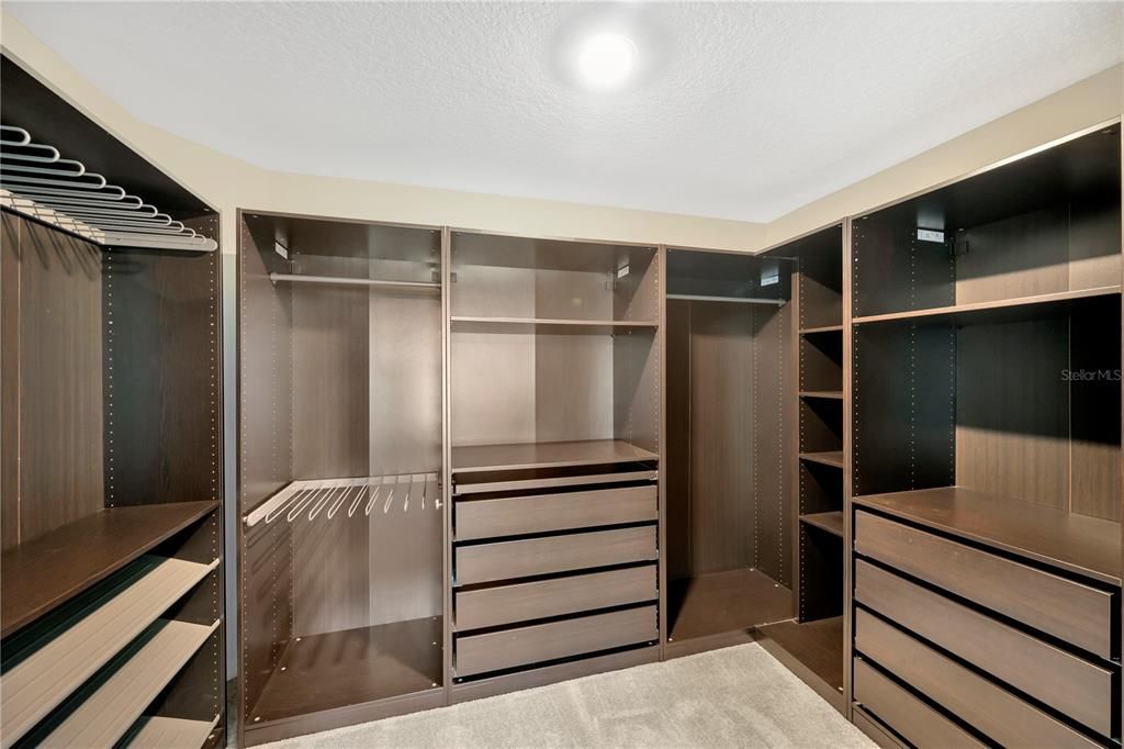 11' x 8' walk-in closet with custom shelving in the primary suite.