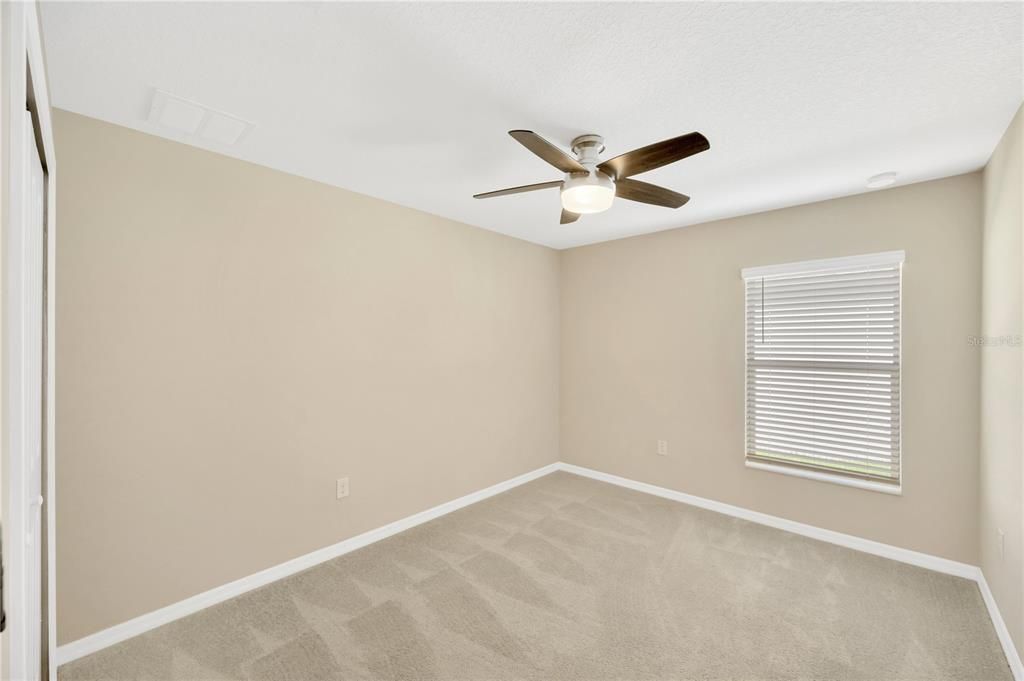 Secondary bedroom #3 is 12' x 10' with ceiling fan, built-in closet and carpet.