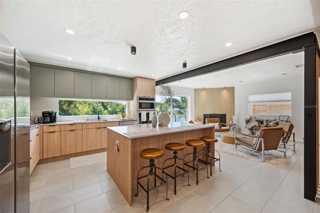 Fabulous kitchen with European style cabinetry, quartz counters and breakfast bar