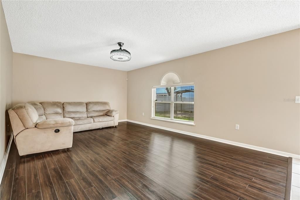 expansive family room, with its warm vinyl plank flooring