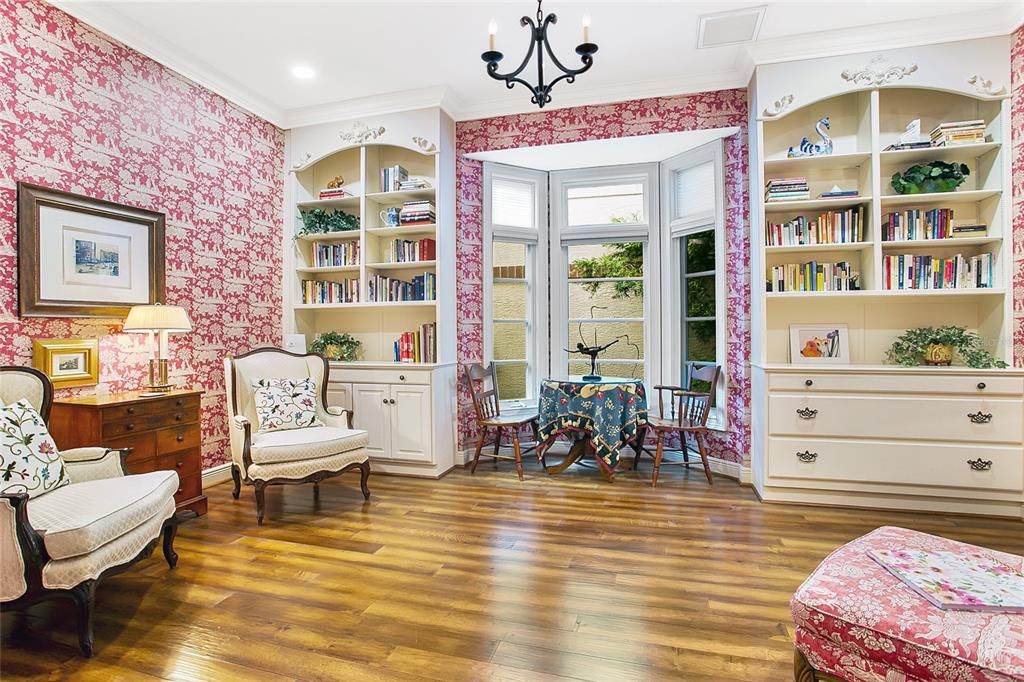 Charming reading room features custom built-in bookcases with storage cabinets and bay window.  This room is just off the kitchen for those who prefer a formal dining room.