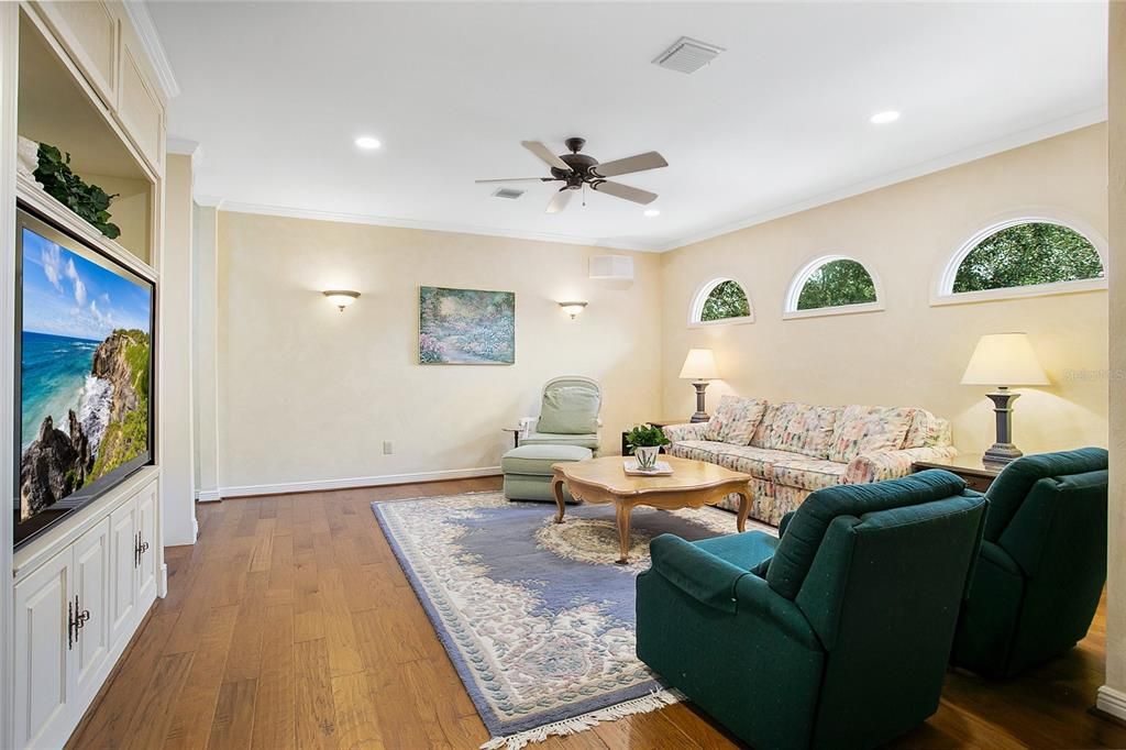 Upstairs family room with view of entertainment cabinet with abundant storage