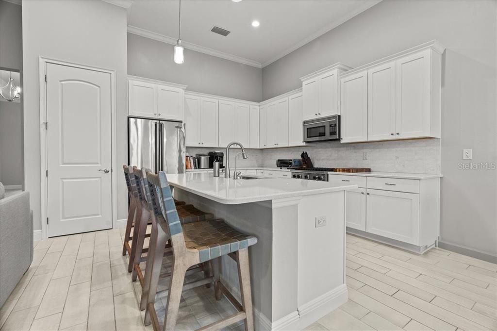 Eat In Kitchen featuring Stone Counters and Tile backsplash