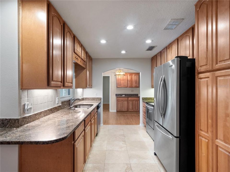 Kitchen view toward formal dining and primary bedroom