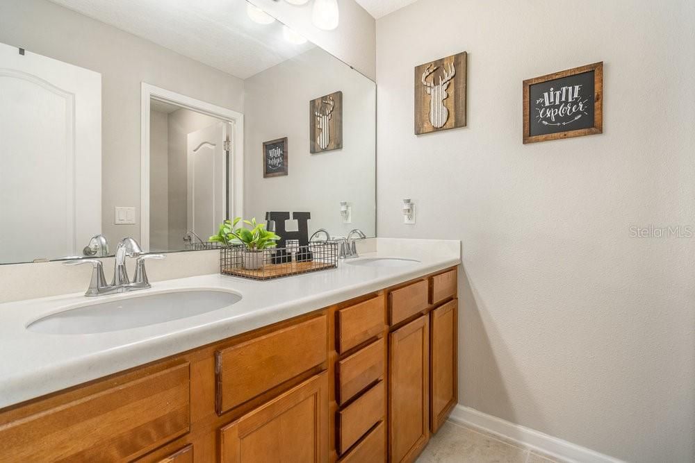 Guest Bathroom with Corian counters and Tub/shower combo.