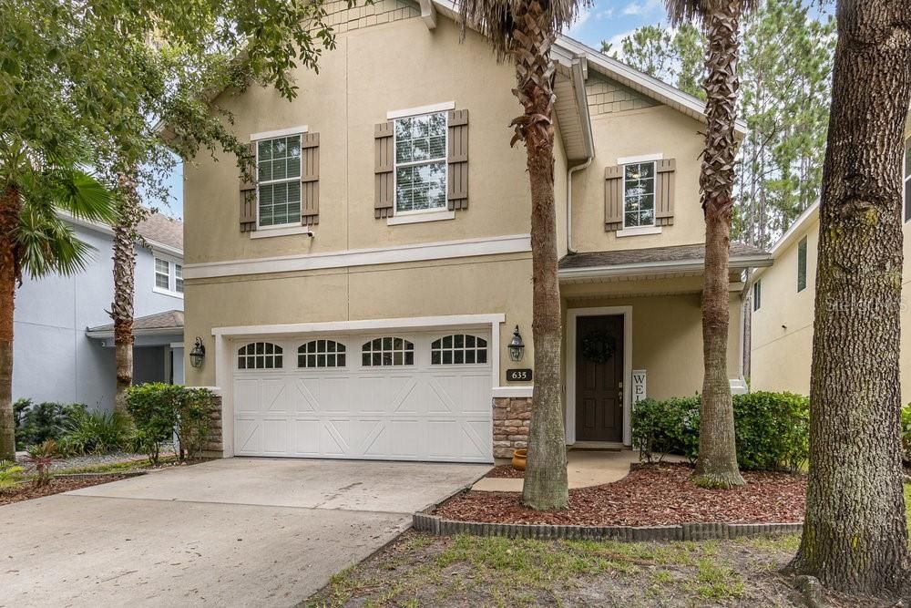 Front Exterior with welcoming, covered front porch and security camera.