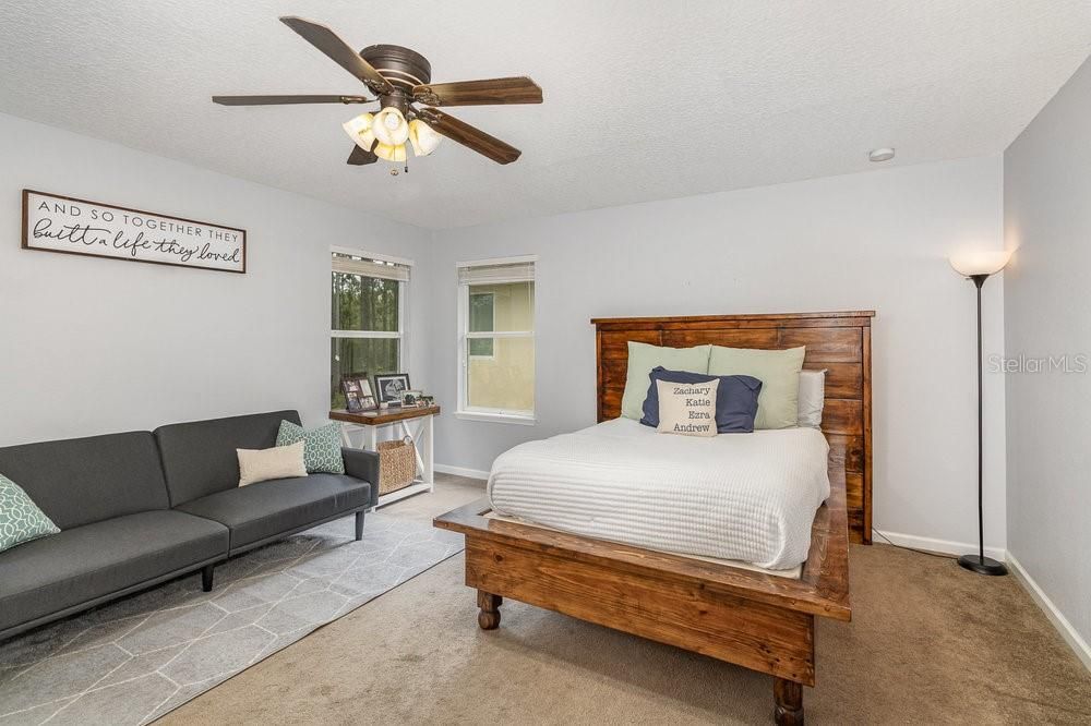 Primary Bedroom with En Suite bathroom, ceiling fan and Walk-in closet.