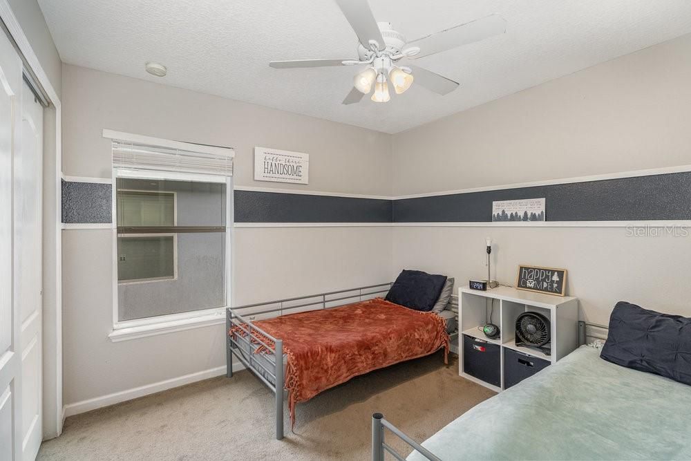 Secondary bedroom with ceiling fan.