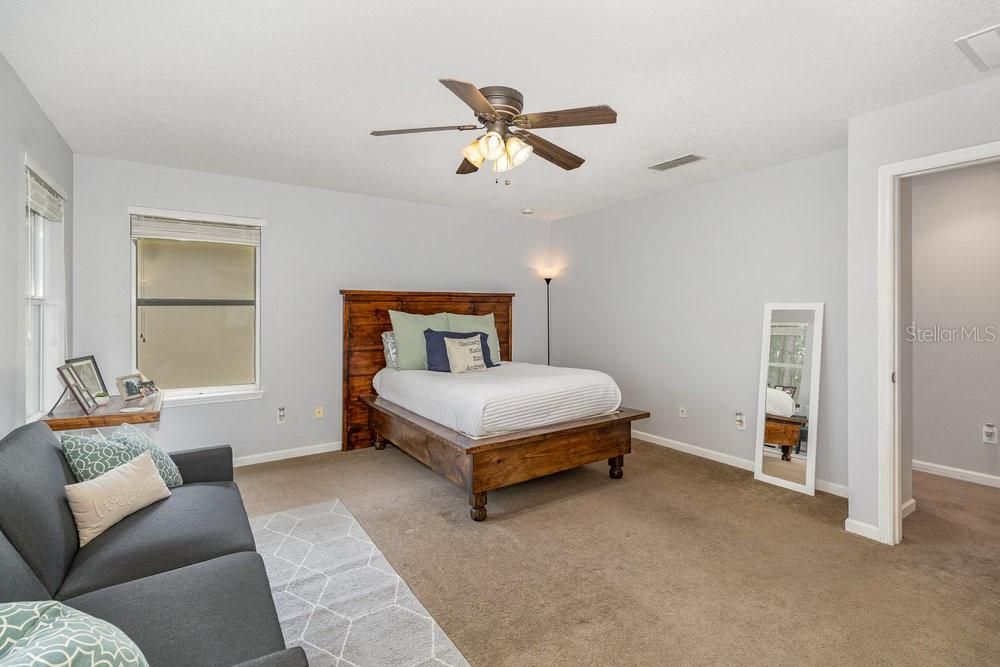 Primary Bedroom with En Suite bathroom, ceiling fan and Walk-in closet.