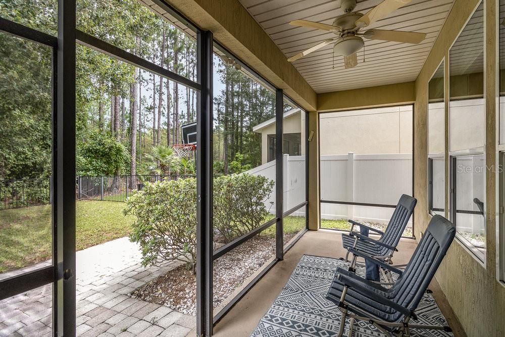 Screened back porch overlooking fenced yard on conservation lot.