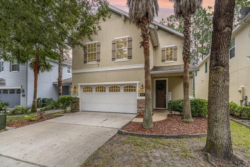 Front Exterior with welcoming, covered front porch and security camera.