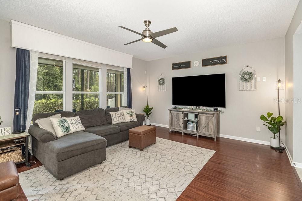 Family Room with Engineered wood flooring and ceiling fan.