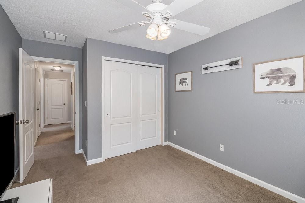 Secondary bedroom with ceiling fan.