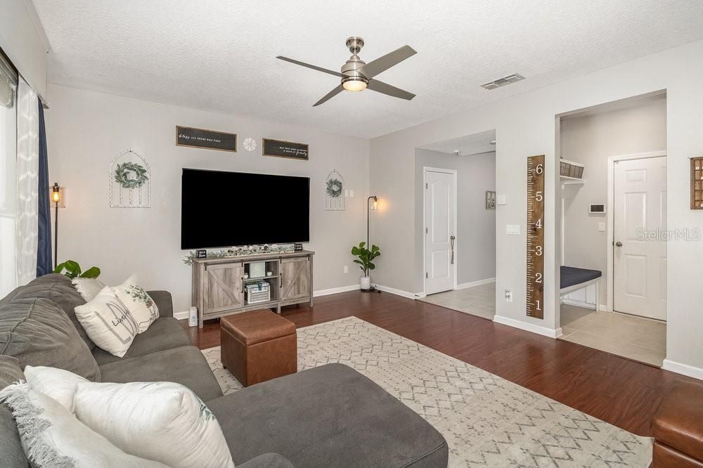 Family Room with Engineered wood flooring and ceiling fan.