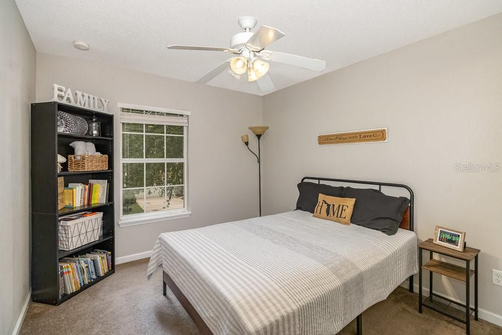 Secondary bedroom with ceiling fan.