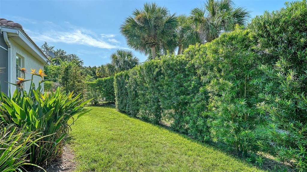 Landscaped groundsshowcasing numerous palms, and tropical plantings