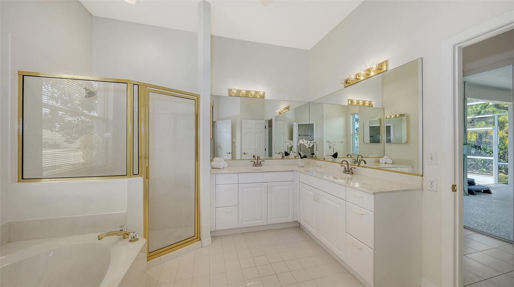 Featuring dual sinks, soaking tub, glass-enclosed shower