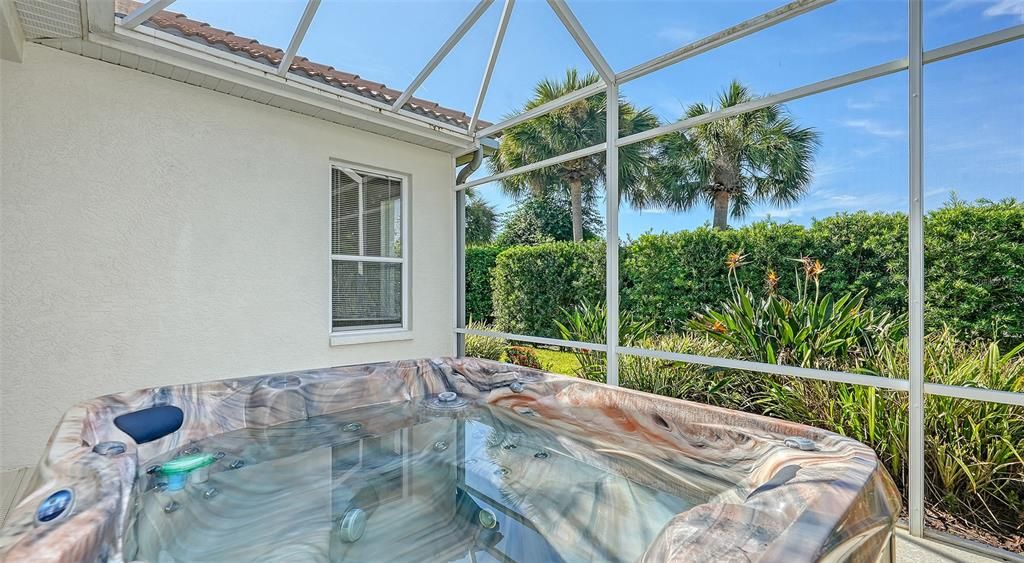 Inviting, screened-in spacefeaturing a sparkling hottub with cover