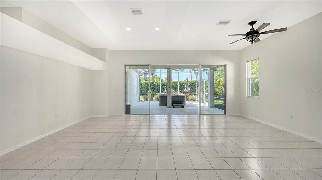 The inviting living/ dining with 11' ceilingspace is bathed in natural light