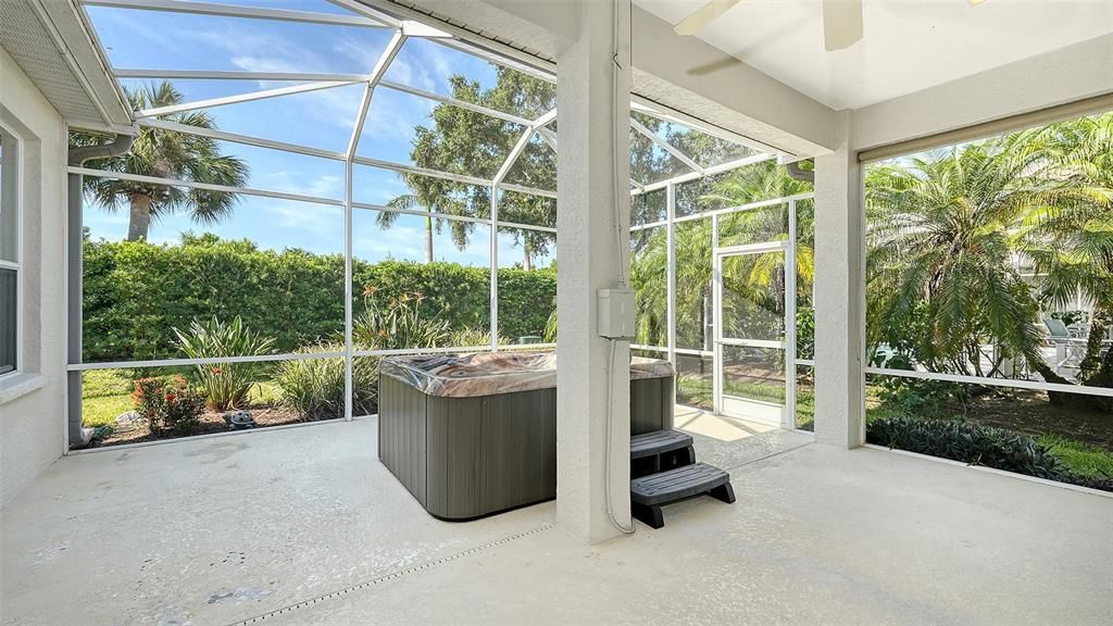 Shaded sitting area withceiling fan perfect for enjoying the Florida sunshine and entertaining