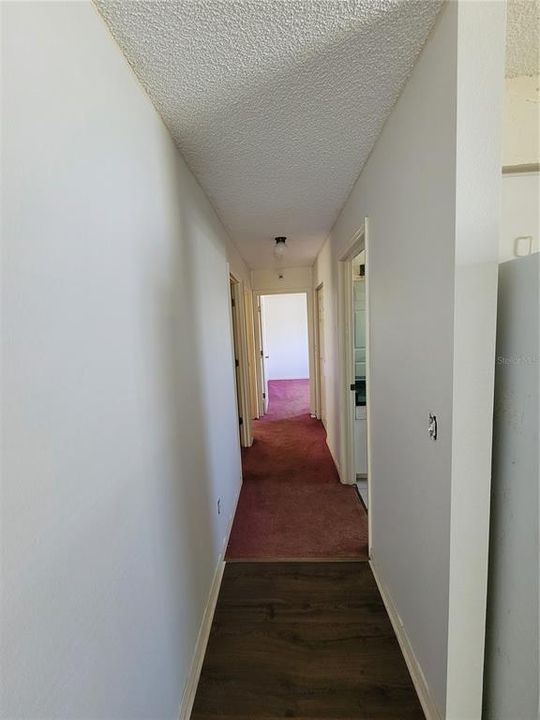 hallway looking from kitchen to bedrooms