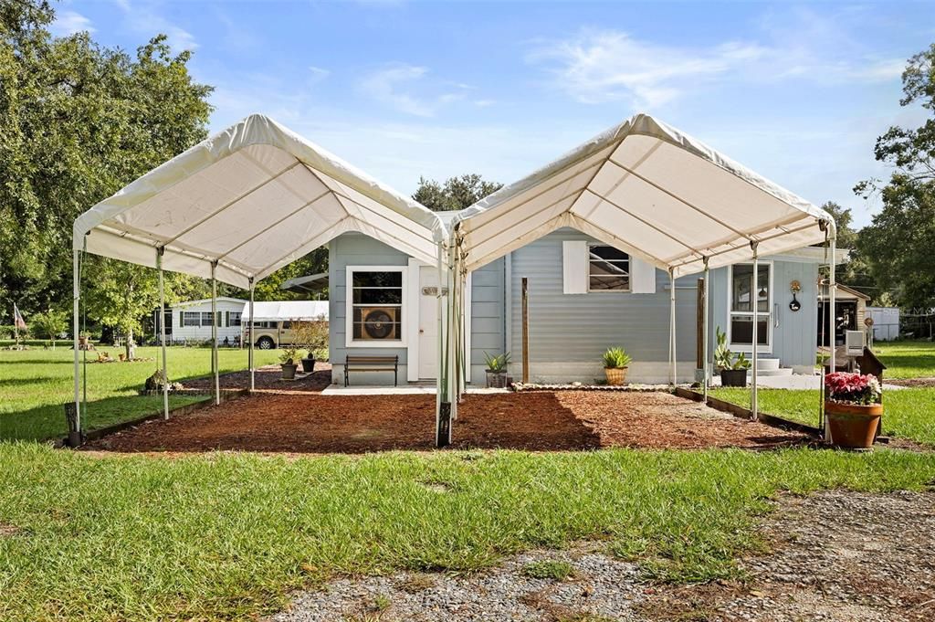 Two covered parking spaces, front door on left