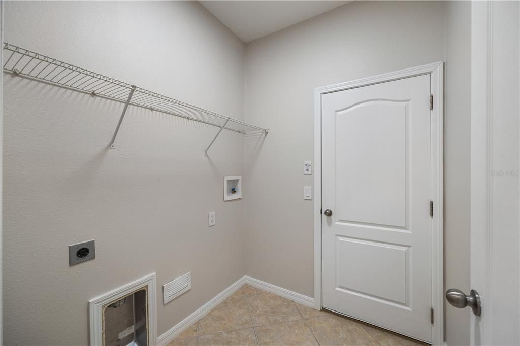 Indoor laundry room off of the garage entrance