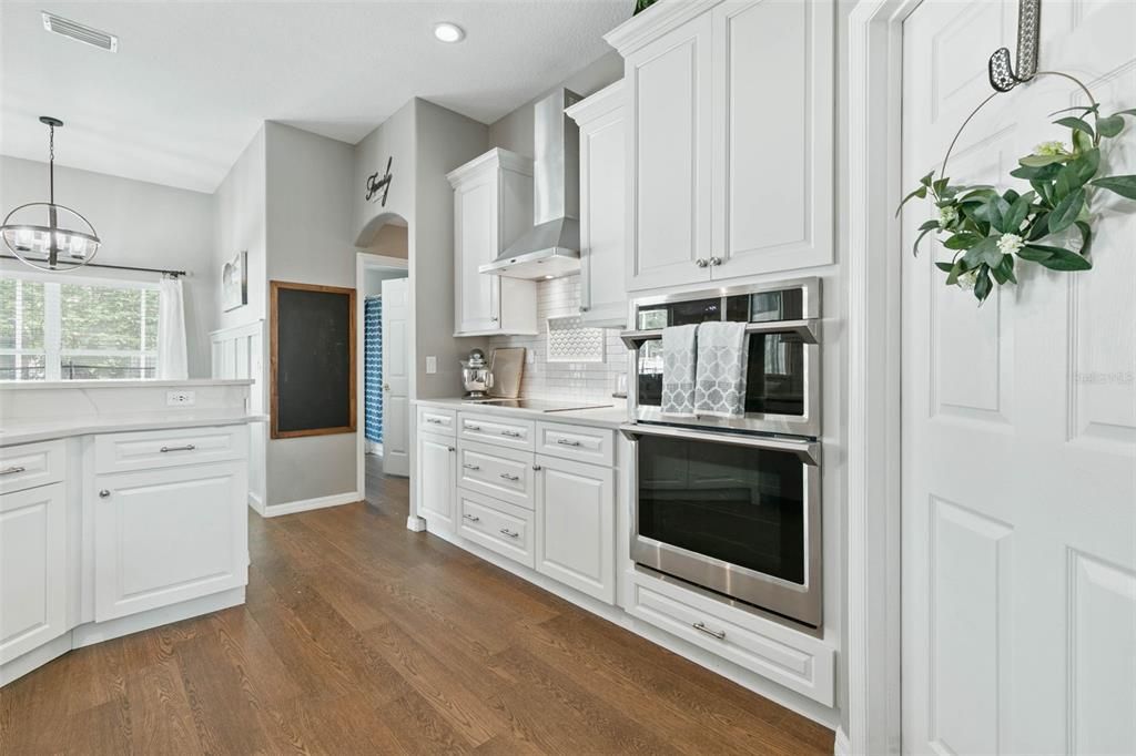 Stunning updated Open kitchen with custom cabinetry, quartz countertops and stainless steel appliances.