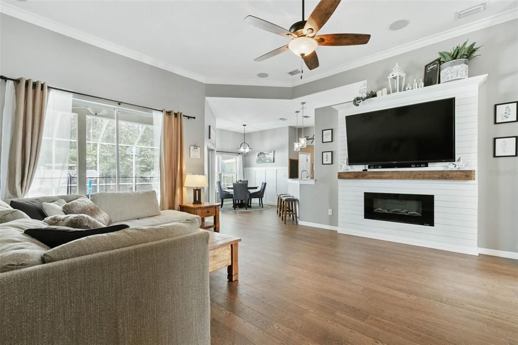 Large living room open to kitchen, with sliders to Pool